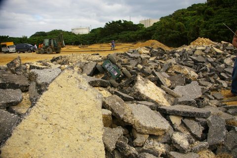 1986 Ford Bronco - A remote control car is partially buried in debris at a construction site.
