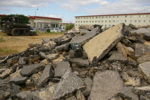 1986 Ford Bronco - RC rock crawler navigating a pile of demolition debris.