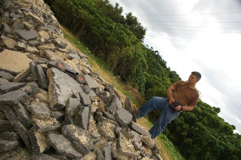 1986 Ford Bronco - A person operates a remote control car on a pile of broken asphalt and rocks.