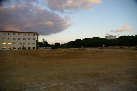 1986 Ford Bronco - A wide view of a construction site at dusk, with a large building and a water tower visible.