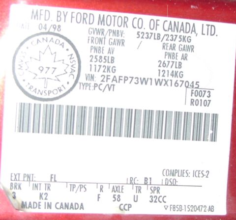 1998 Ford Crown Victoria - A close-up of a vehicle's door sticker, showing manufacturing details and VIN.