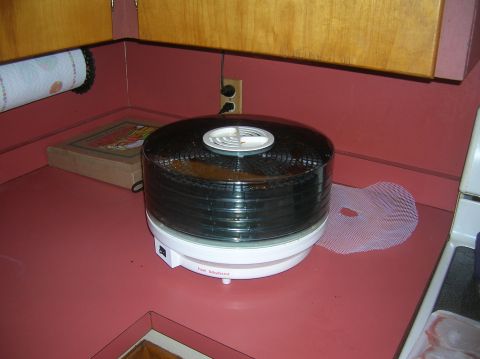 1996 Ford Bronco - A food dehydrator sits on a kitchen counter next to a roll of paper towels and a box.