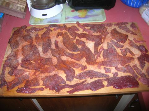 1996 Ford Bronco - Meat strips prepared for drying on a cutting board, with kitchen appliances visible in the background.