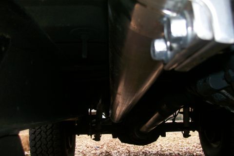 1992 Ford C-350 (Centurion Conversions) - Underside view of vehicle's exhaust system and chassis components.