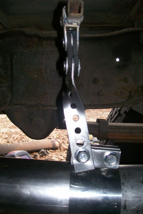1992 Ford C-350 (Centurion Conversions) - Close-up of a custom exhaust pipe clamp and bracket assembly.