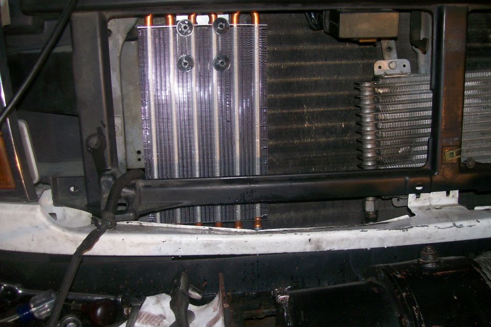 Radiator and AC condenser assembly behind grille