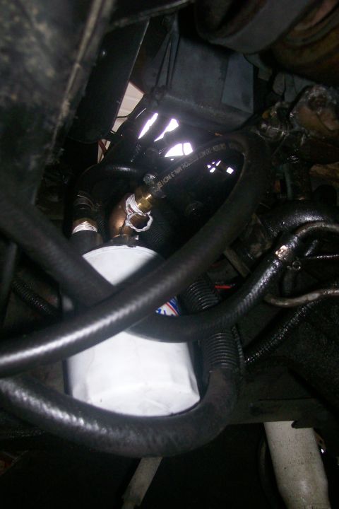 1992 Ford C-350 (Centurion Conversions) - Close-up view of an engine oil filter and associated plumbing, likely part of a vehicle's maintenance.