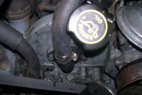 1992 Ford C-350 (Centurion Conversions) - The engine oil cap is visible in this close-up shot of engine components.