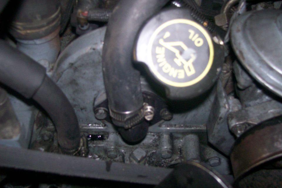 Close-up of an engine oil cap with yellow lettering on a black background