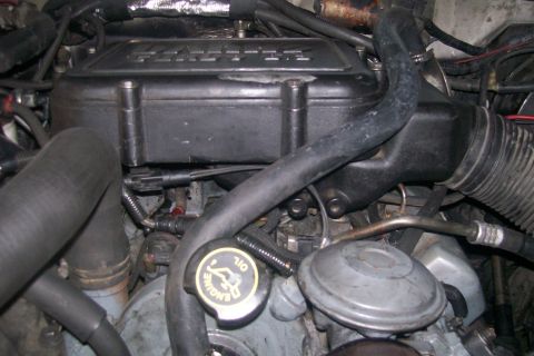 1992 Ford C-350 (Centurion Conversions) - Close-up view of the engine compartment of a 1992 Ford C-350 (Centurion Conversions), highlighting engine components and hoses.