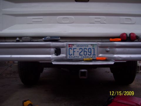 1978 Ford Bronco - The rear of a Ford truck is shown, with a license plate and tools on the bumper.