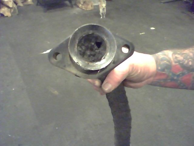 Exhaust pipe flange held in hand
