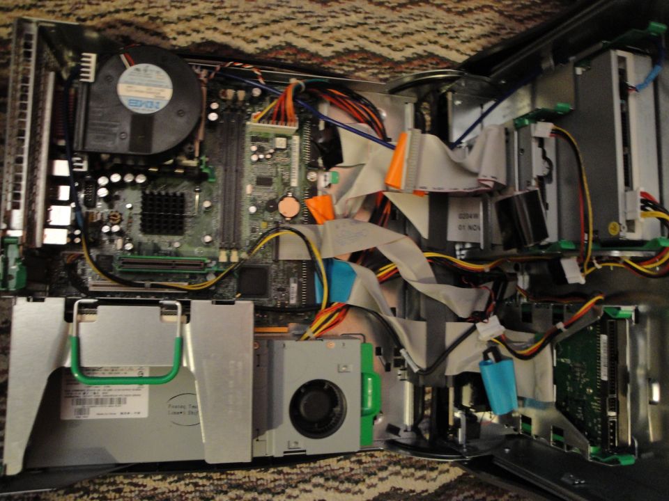 Internal components of a desktop computer, including motherboard, fans, and cables