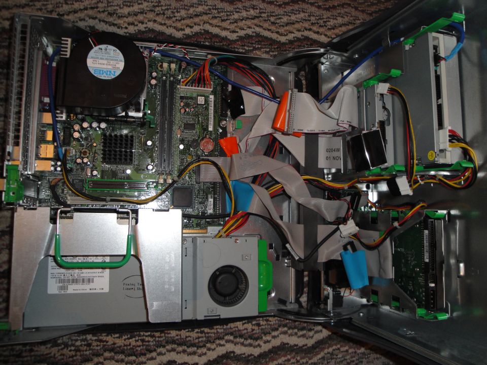 Inside of a desktop computer with motherboard, fans, and cables visible