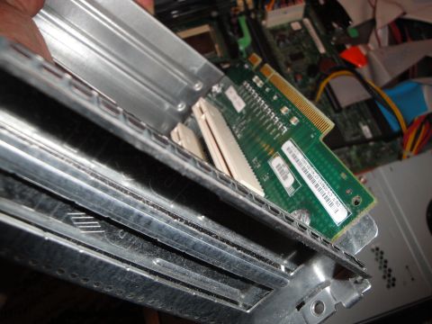 1993 Ford Taurus - A circuit board is being installed into a computer's internal frame, showing internal components.