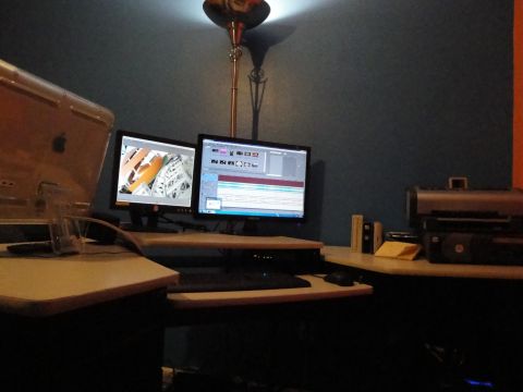 1993 Ford Taurus - A computer workstation features dual monitors, a keyboard, mouse, and a floor lamp casting light on the wall.