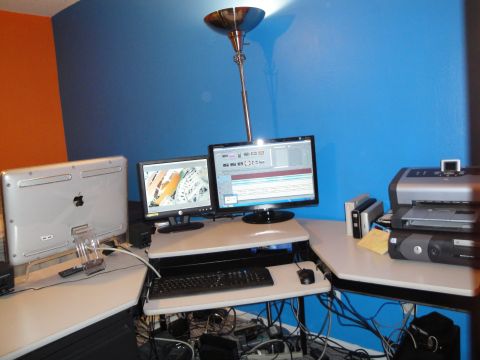 1993 Ford Taurus - A cluttered computer workstation features multiple screens and peripherals, with a printer on the right side.