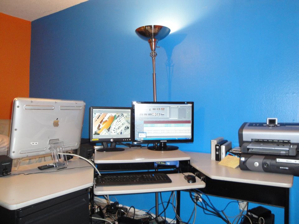 Computer setup with two monitors, keyboard, mouse, and printer