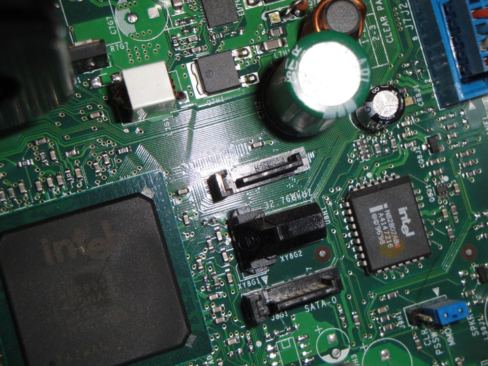 Close-up of a computer motherboard showing Intel processors and SATA ports