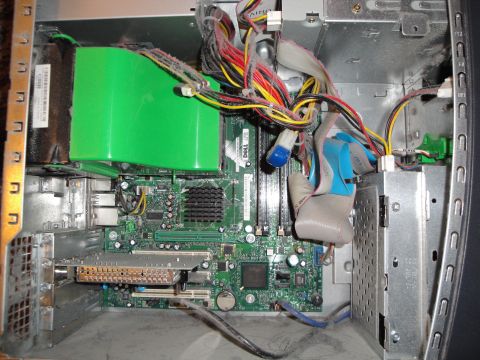 1993 Ford Taurus - Internal components of a computer, including motherboard, power supply, and wiring, covered in dust.