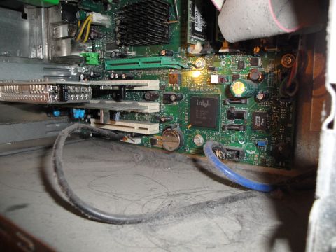 1993 Ford Taurus - A close-up view of a dusty computer motherboard, showing internal components and wiring.