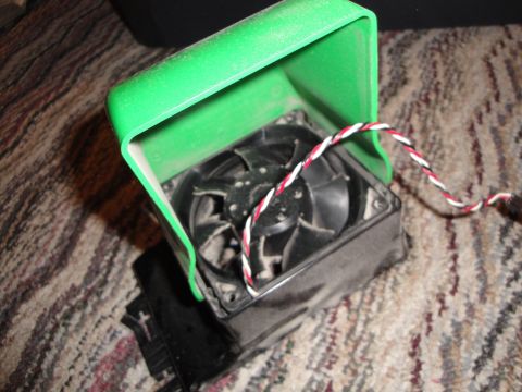 1993 Ford Taurus - A computer fan is shown with a green protective cover, resting on a carpeted surface.