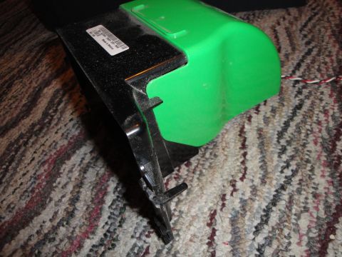 1993 Ford Taurus - Close-up of a green plastic component with a black bracket and a label.