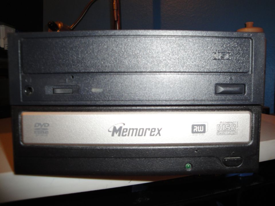 Two computer drives stacked, one is a Memorex DVD RW drive