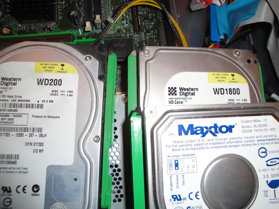 Computer case interior with three hard drives: two Western Digital and one Maxtor