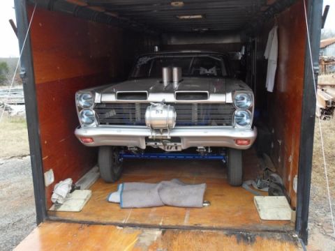 1963 Ford Fairlane - A modified 1963 Ford Fairlane drag car is parked inside a trailer, ready for transport.