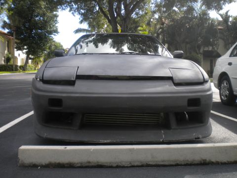 1991 Nissan 240SX - Front view of a 1991 Nissan 240SX with pop-up headlights and an aftermarket bumper.