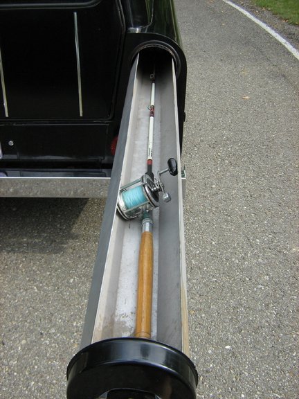 1991 Ford Bronco - A fishing rod and reel are stored in a custom compartment on the side of a vehicle.