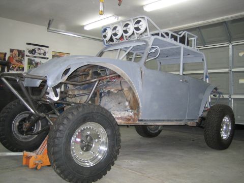 1996 Ford Bronco - This custom off-road vehicle, likely a modified Volkswagen Beetle, is undergoing construction in a garage.