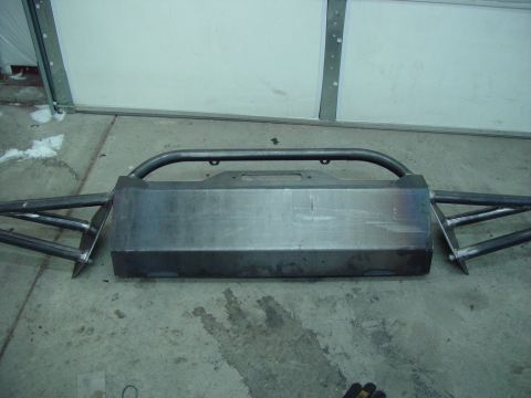 1993 Ford Bronco - A custom steel bumper with an integrated brush guard and winch mount is shown, likely for an off-road vehicle.