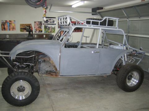 1996 Ford Bronco - Custom buggy project in garage, unfinished body, roll cage, and off-road tires visible.
