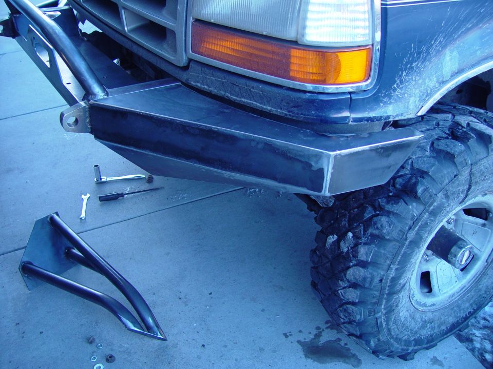 Custom metal bumper installed on a 1992 Ford Bronco, with tools nearby