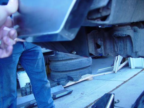 1993 Ford Bronco - Close-up view of a vehicle's undercarriage, focusing on suspension and protective elements.