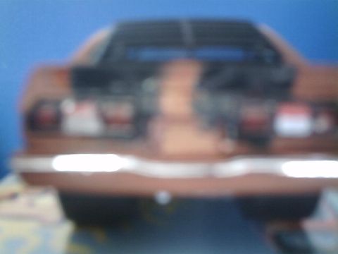 1978 Ford Mustang II - The rear of a brown car is visible, horizontal taillights and a chrome bumper. The registry claims it is a 1978 Ford Mustang II, but this i…