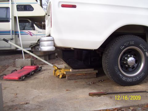 1978 Ford Bronco - A white pickup truck's rear wheel and bumper are visible, with an RV parked nearby. The date 12/16/2009 is watermarked on the image.