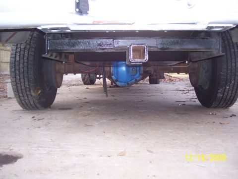 1978 Ford Bronco - Underside view of a vehicle's rear axle, hitch, and tires.