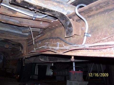 1978 Ford Bronco - Undercarriage view shows brake and fuel lines, with significant rust on the frame components.