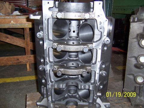 1972 Ford Ranchero - Bare V8 engine block stood on end and shot from the bottom, showing honed cylinder bores, the main bearing bulkheads and bolted two-bolt ma…