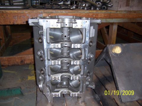 1972 Ford Ranchero - Machined V8 engine block standing on end with the main caps removed, looking into the crankcase at the bare main bearing saddles, honed bor…