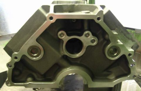 1972 Ford Ranchero - Close-up of the front face of a machined V8 engine block, looking straight at the timing cover sealing surface with the cam bore, three-bol…