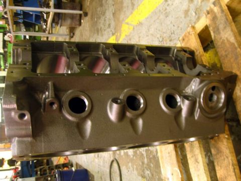 1972 Ford Ranchero - Side view of a bare V8 engine block on a pallet in a machine shop, cleaned to bare cast iron with freshly honed cylinder bores and machined…