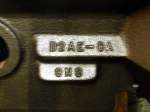 1972 Ford Ranchero - Extreme close-up of a Ford casting number stamped into a machined pad on an engine block, reading "D2AE-CA" above a second pad marked "8N8"…