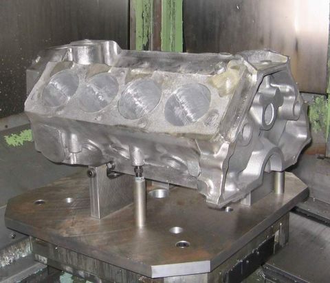 1972 Ford Ranchero - A metal engine block is mounted on a fixture for machining operations.