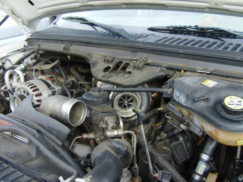1995 Ford Bronco - Close-up of an engine bay, highlighting the turbocharger and associated components.