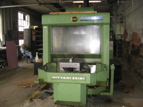 1972 Ford Ranchero - Front view of a green Hitachi Seiki HC500 horizontal machining center with its pallet table and control panel, standing on the concrete flo…