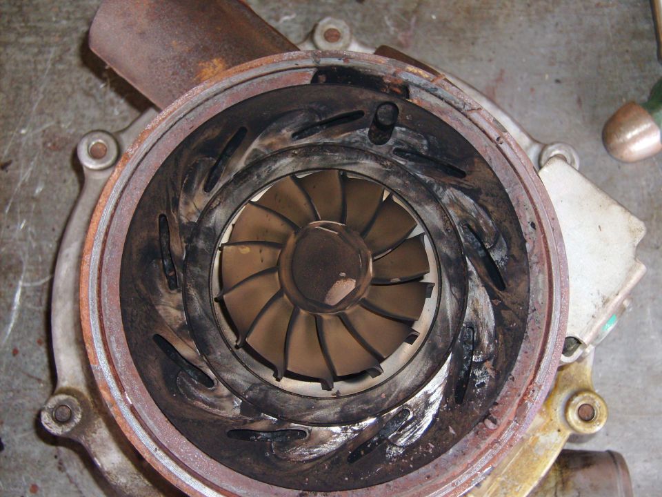 Turbocharger turbine housing cut open showing variable vanes and wheel